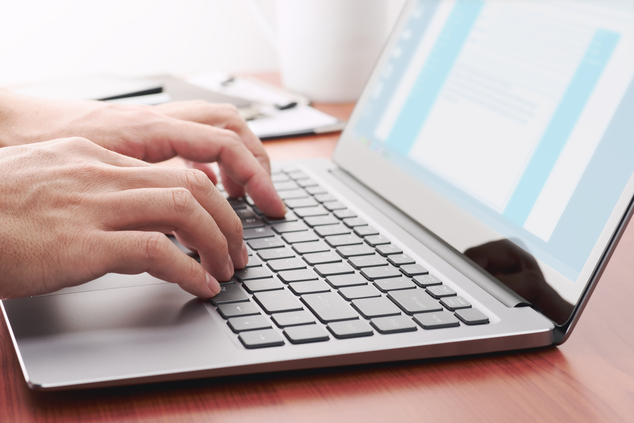 Businessman sending email by laptop.